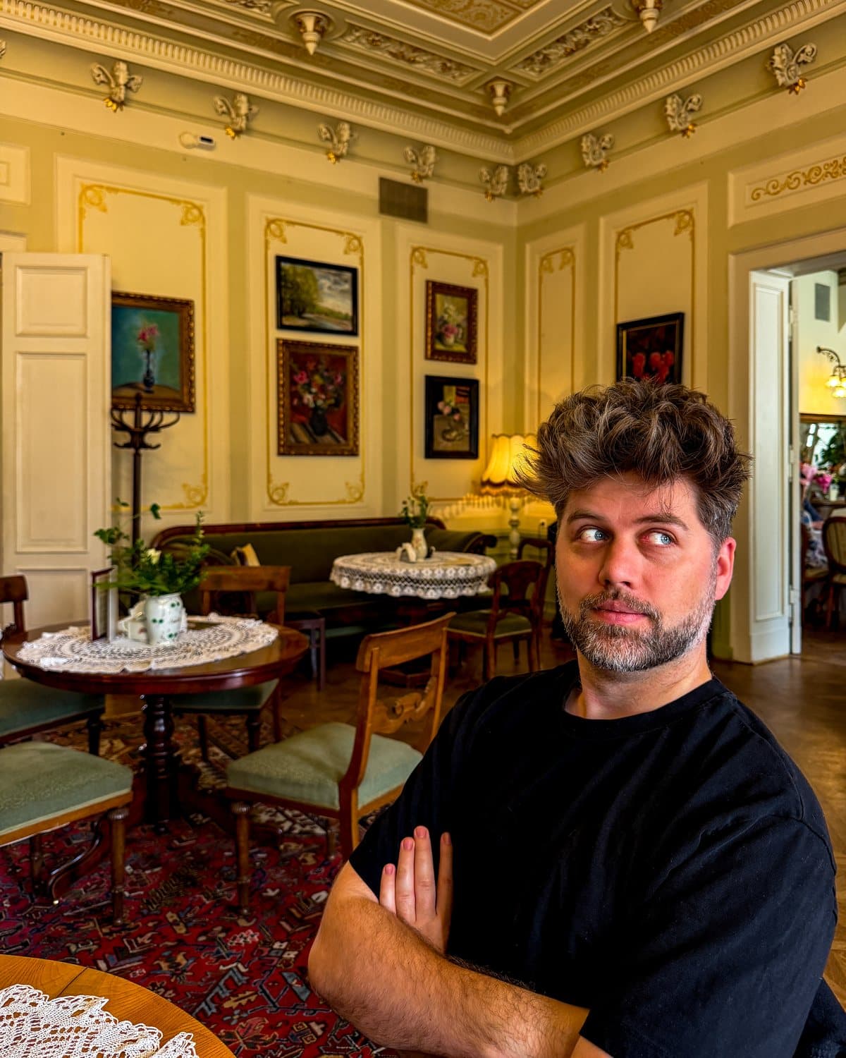 Aleksander, founder of Lieto, in a warm, old-world café.